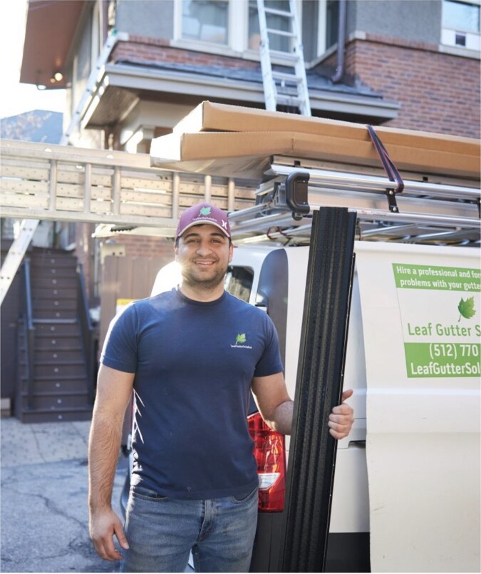 Leaf Gutter and Roofing Solutions professional crew member with company vehicle and gutter materials